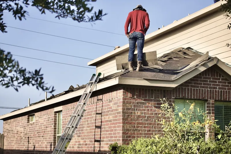 Professional roofer working on a residential roof in Timnath